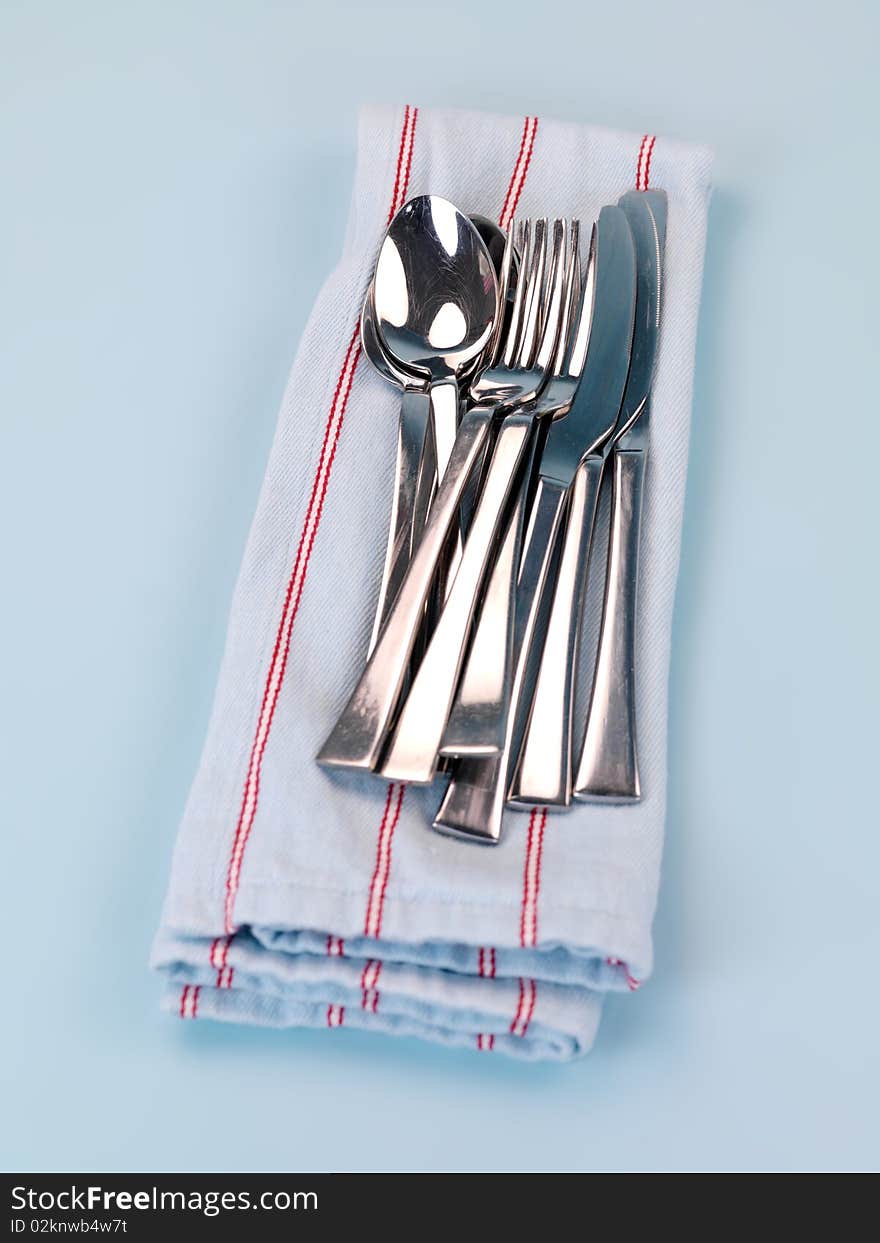 Plates and cutlery isolated against a blue background