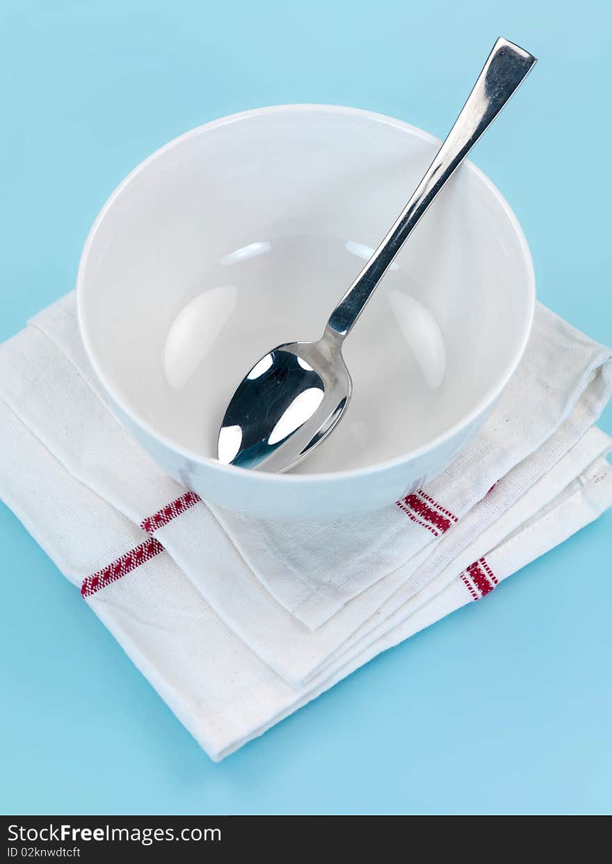 Plates and cutlery isolated against a blue background