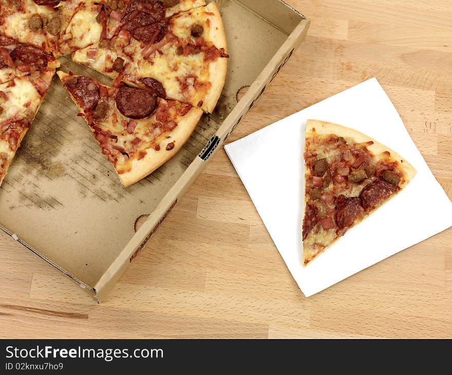 Freshly cooked takeaway pizza on a kitchen bench. Freshly cooked takeaway pizza on a kitchen bench