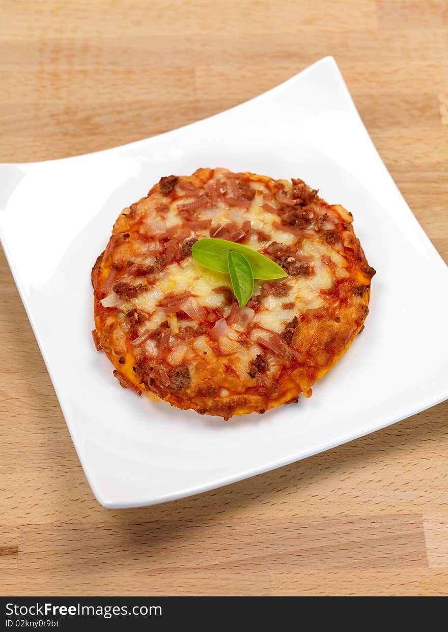 Mini Pizzas isolated on a kitchen bench