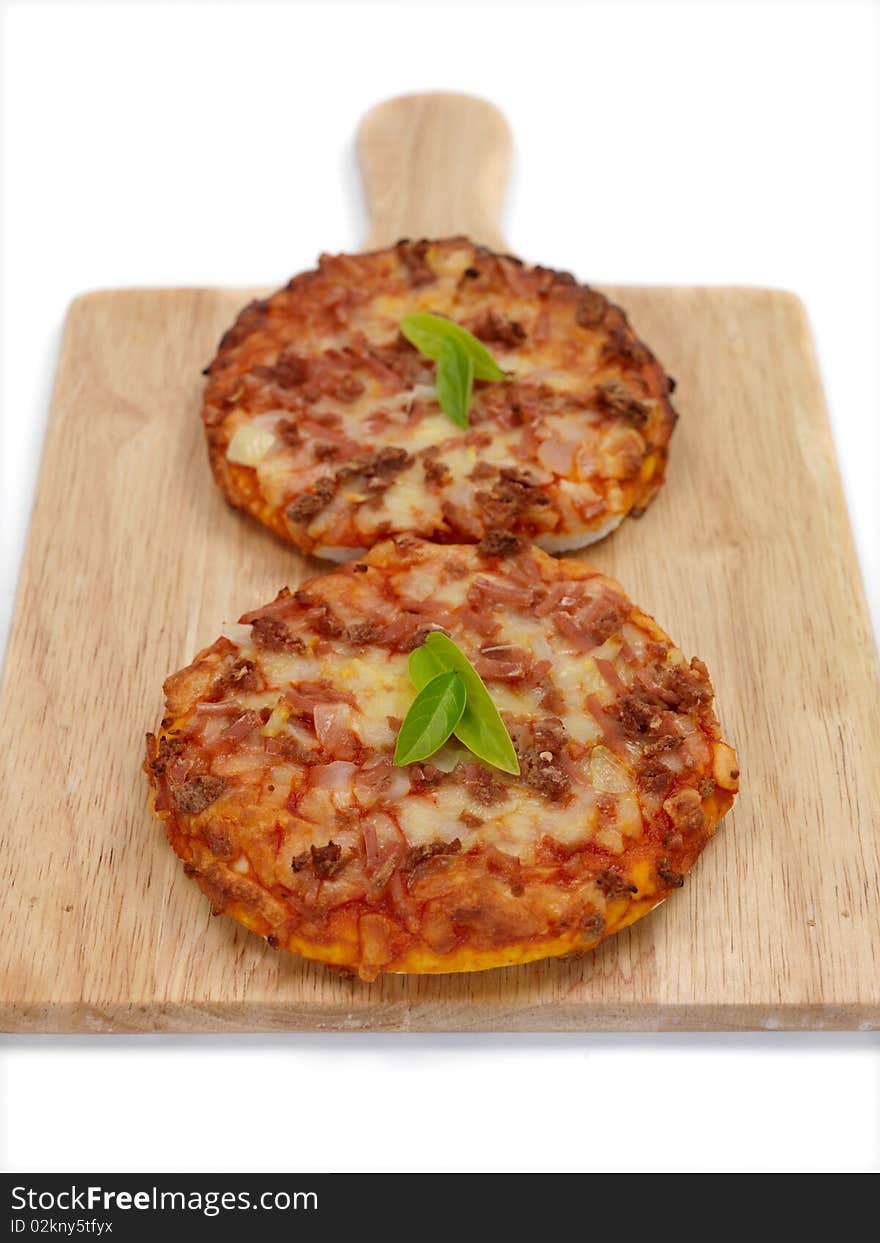 Mini Pizzas isolated on a kitchen bench