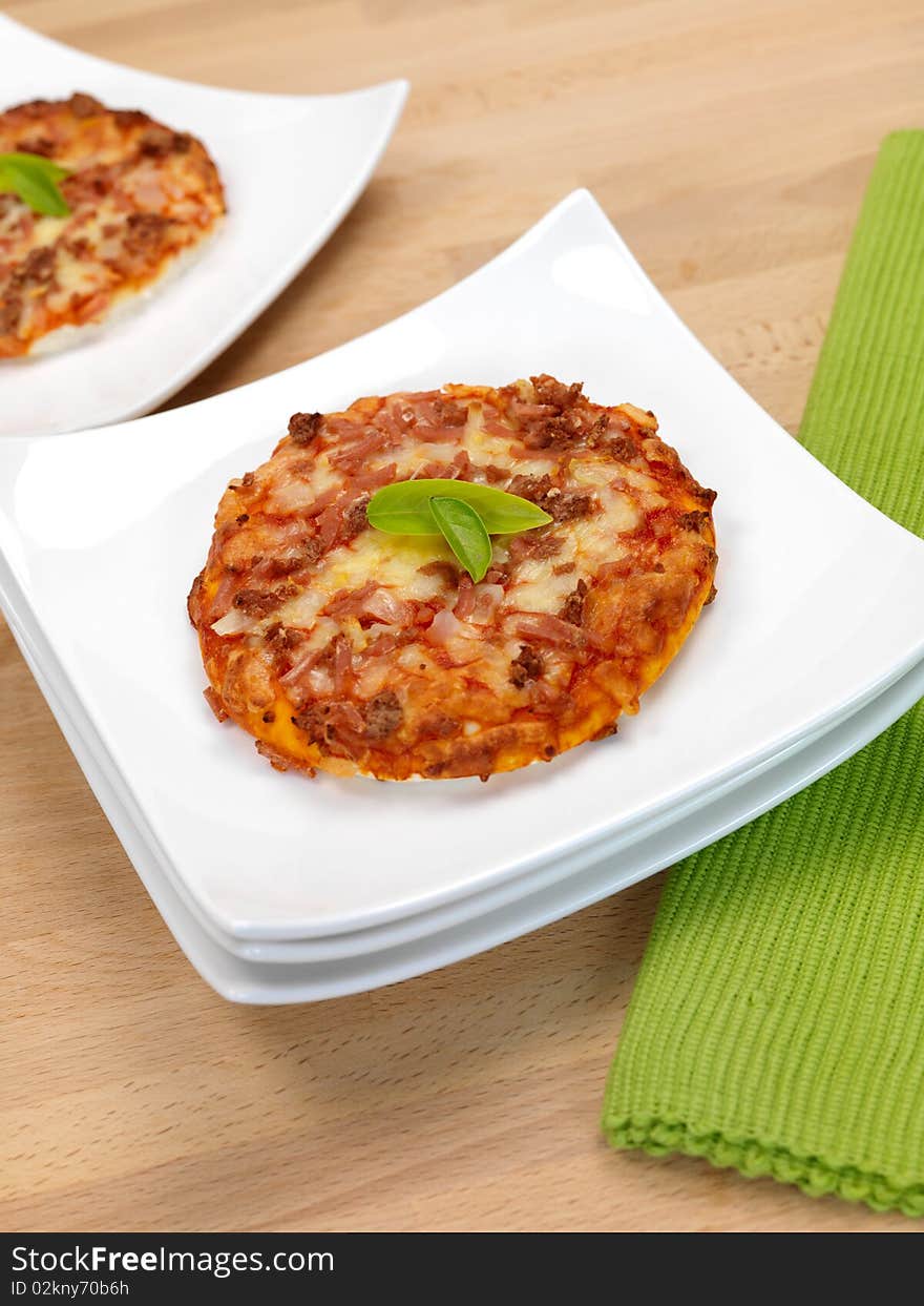 Mini Pizzas isolated on a kitchen bench