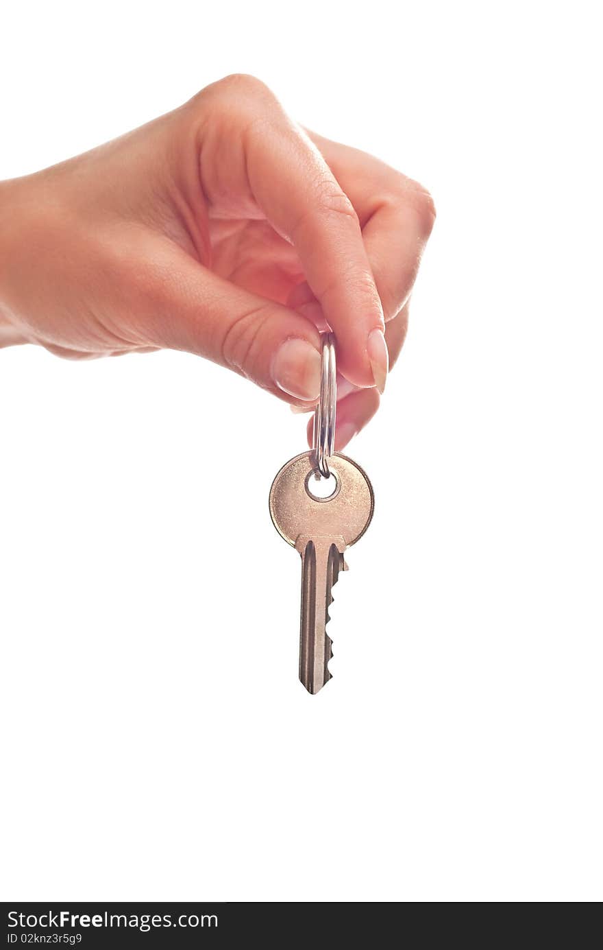 Silver key in woman's hand. Isolated on white. Silver key in woman's hand. Isolated on white