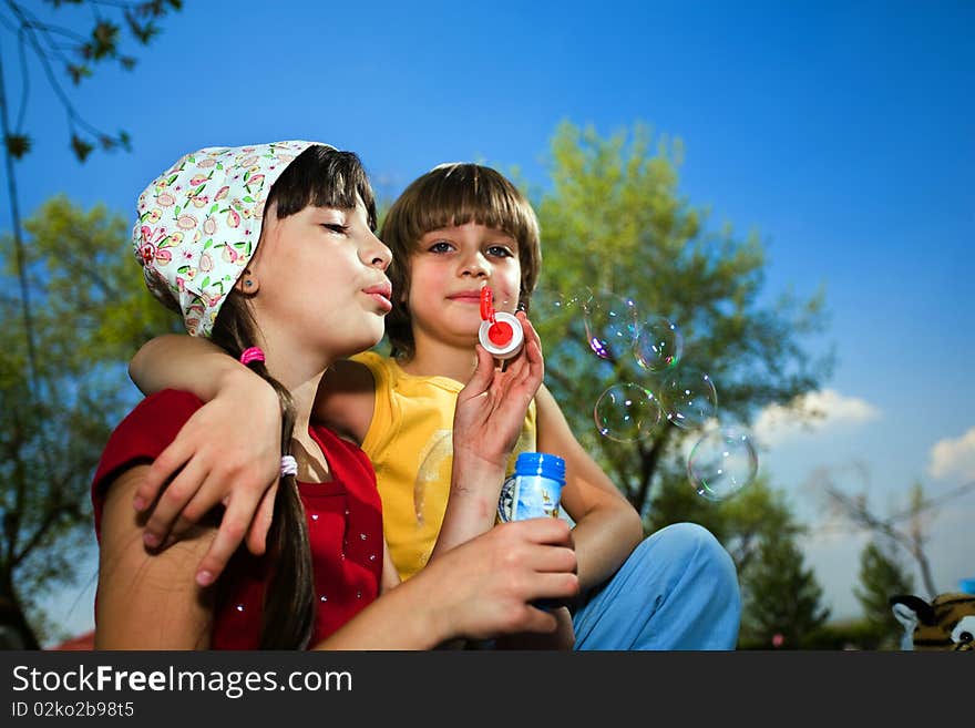 Girl With Soap Bubbles And Boy