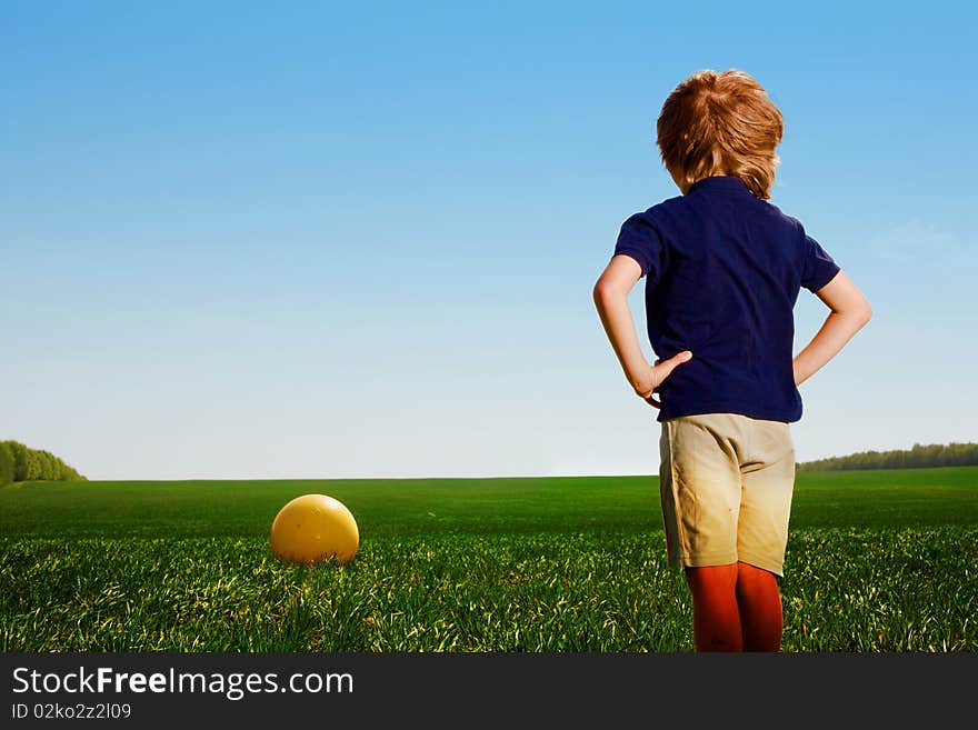 Small boy with ball in field