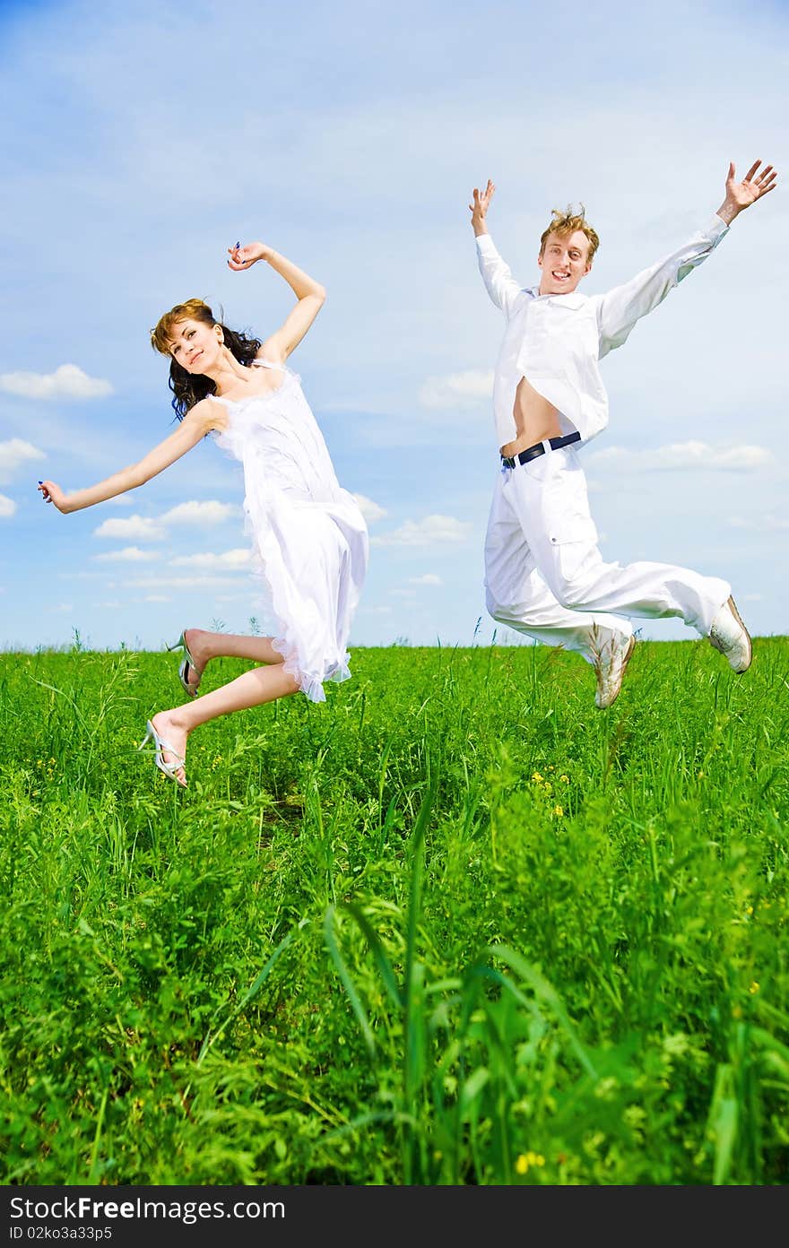 Couple Jump In A Flower Field