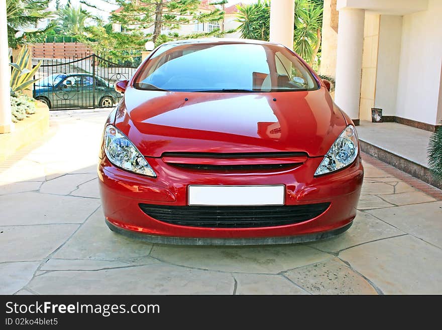 Red car with light reflection.