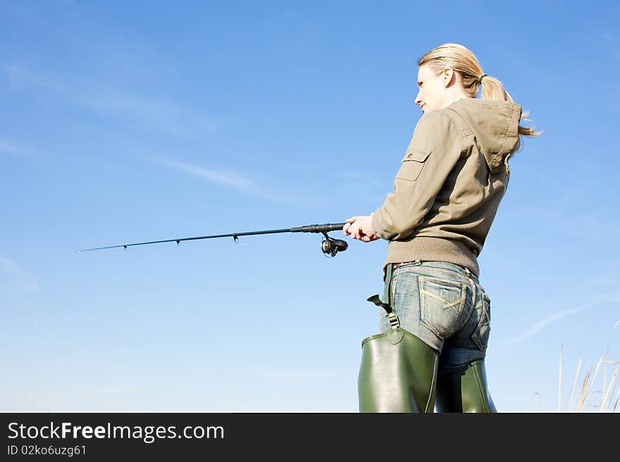 Fishing woman with fishing rod