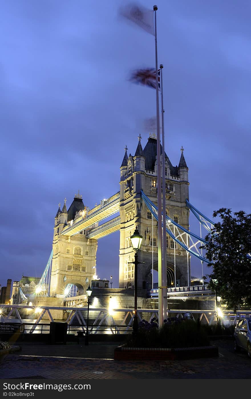 Tower Bridge at night with blue sky in background