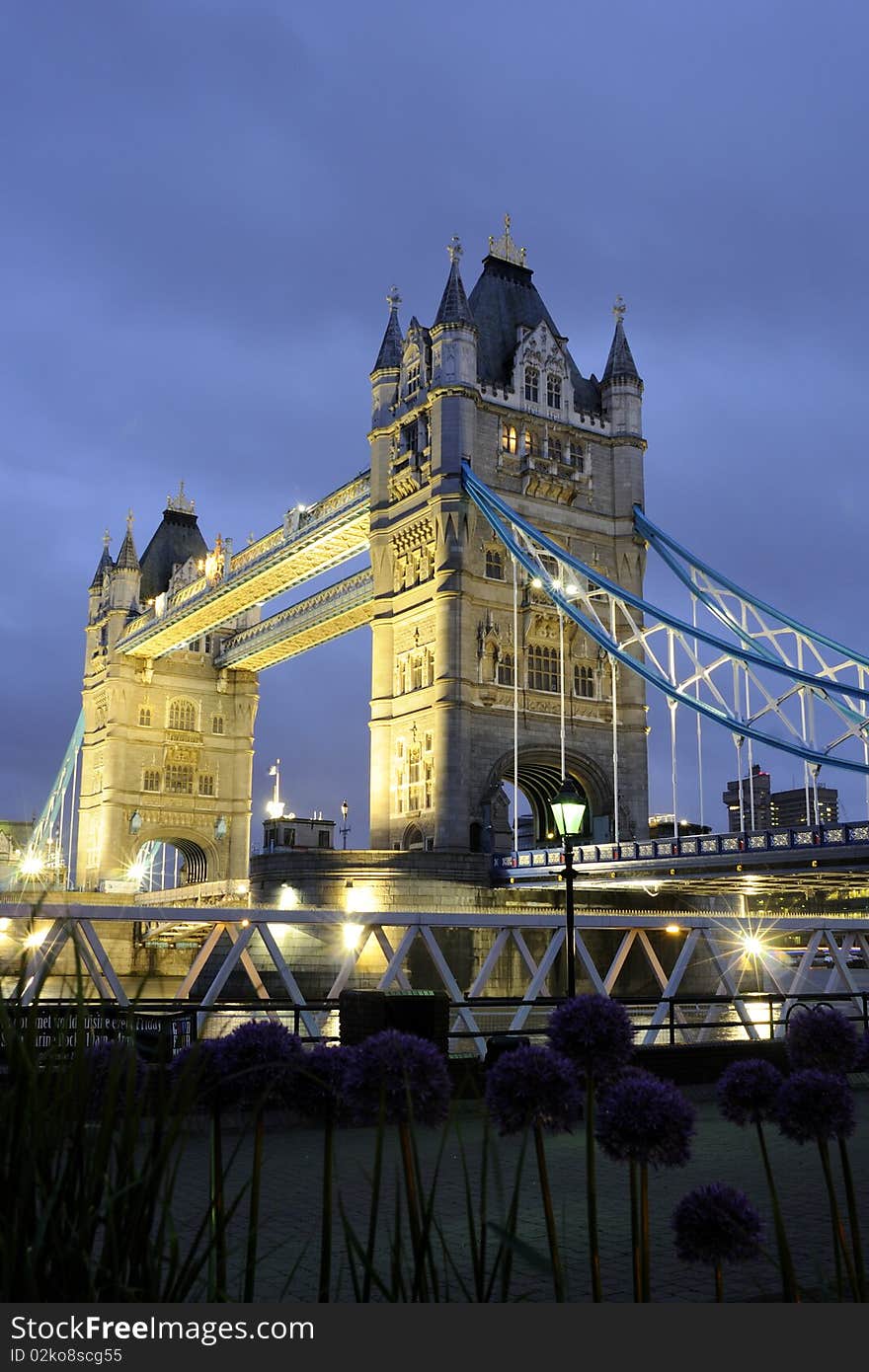 Tower Bridge at night with blue sky in background