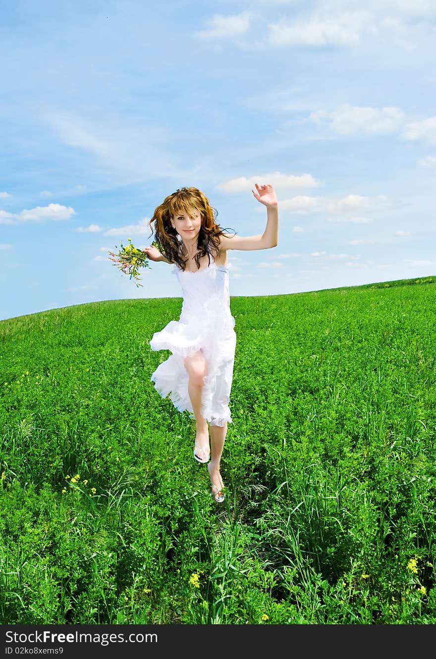 Pretty women run on a meadow