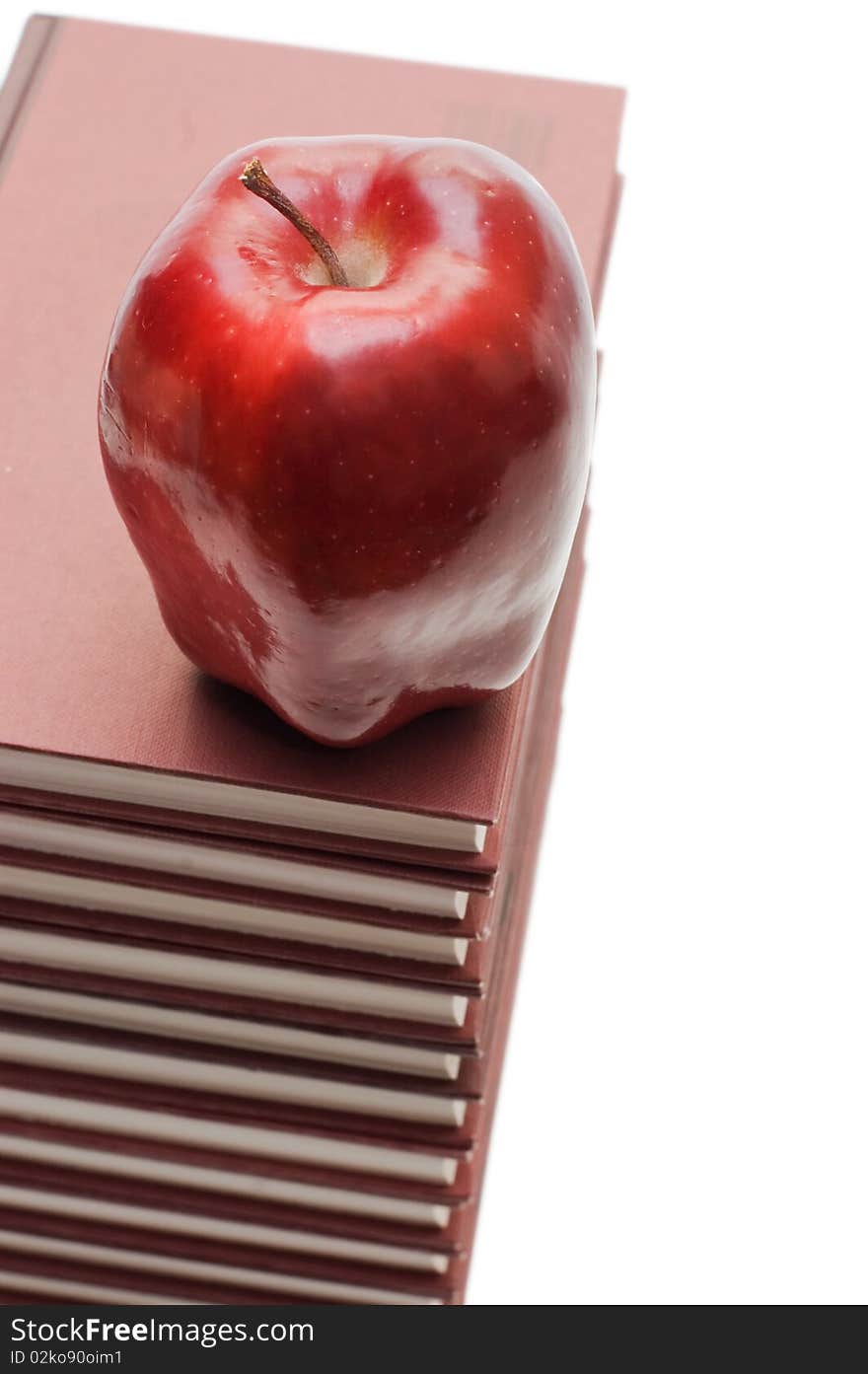 Stack of books and apple isolated