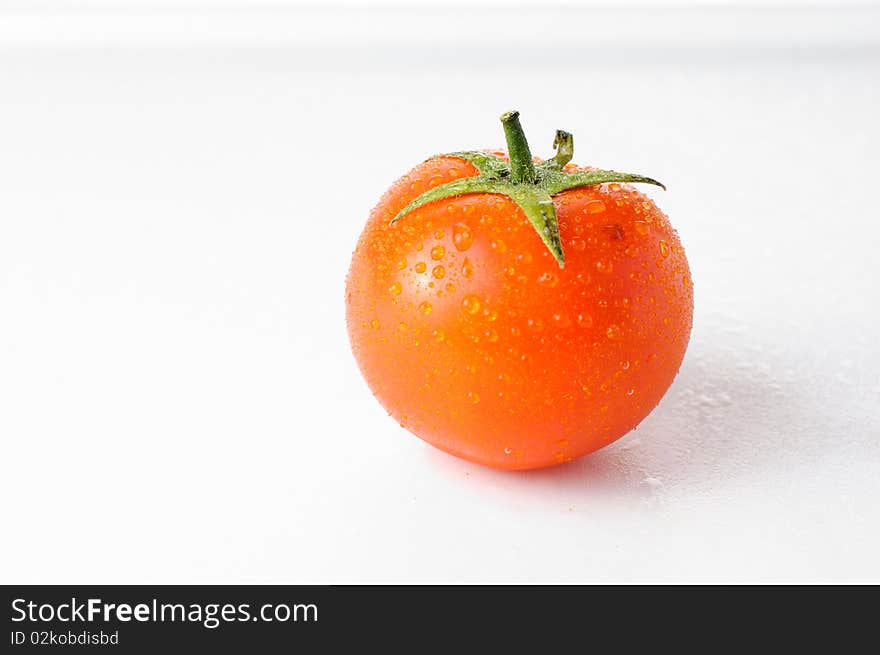 Fresh ripe tomato on a white background