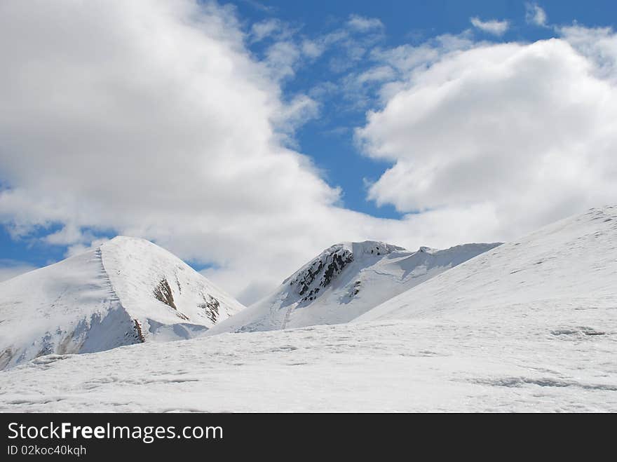 Winter mountain top in a landscape with a white slope. Winter mountain top in a landscape with a white slope