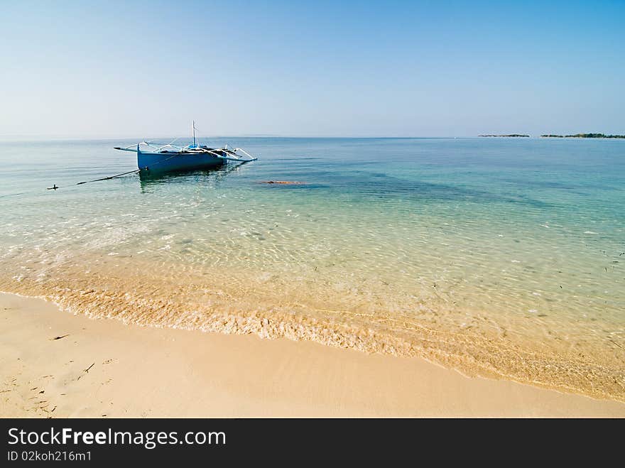 Blue Wooden Boat on a Pristine White Beach