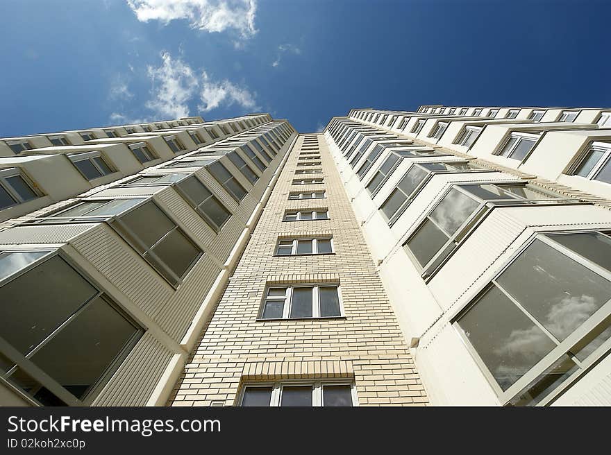 Moscow, Russia, the new multi-storey residential building on a background of blue sky. Moscow, Russia, the new multi-storey residential building on a background of blue sky