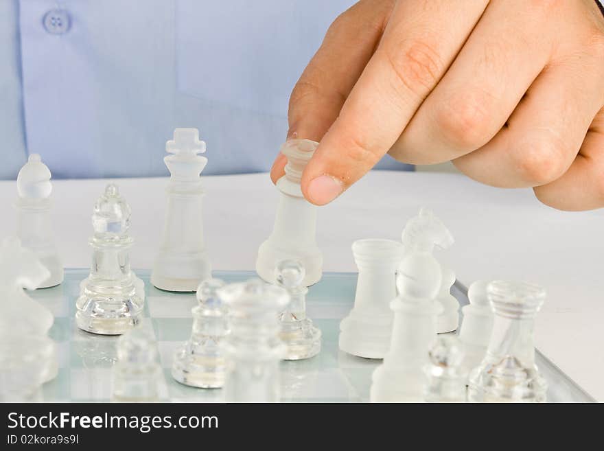 Man making a move on a glass chess. Man making a move on a glass chess