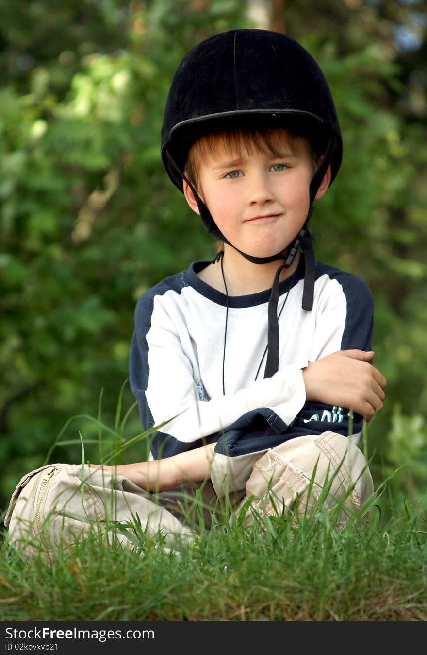 The boy in a cap of the equestrian on  greens