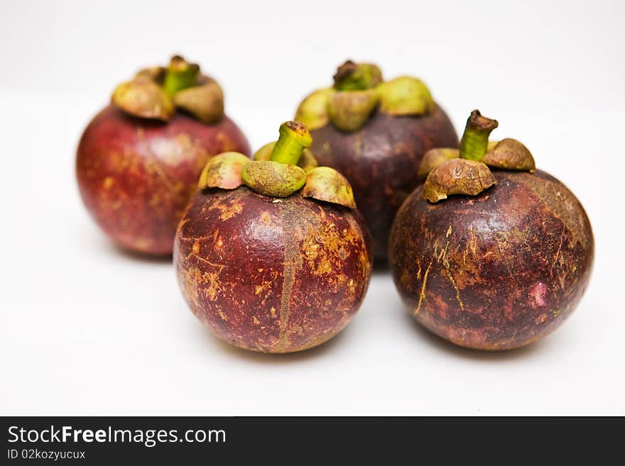 Four Mangosteens on white background