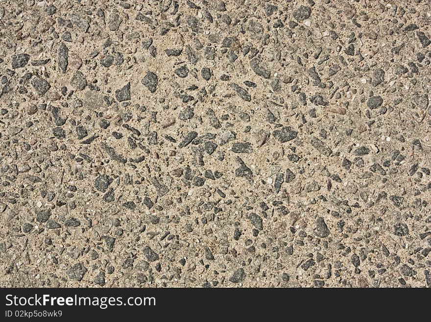 Old asphalt with stones close-up as background. Old asphalt with stones close-up as background