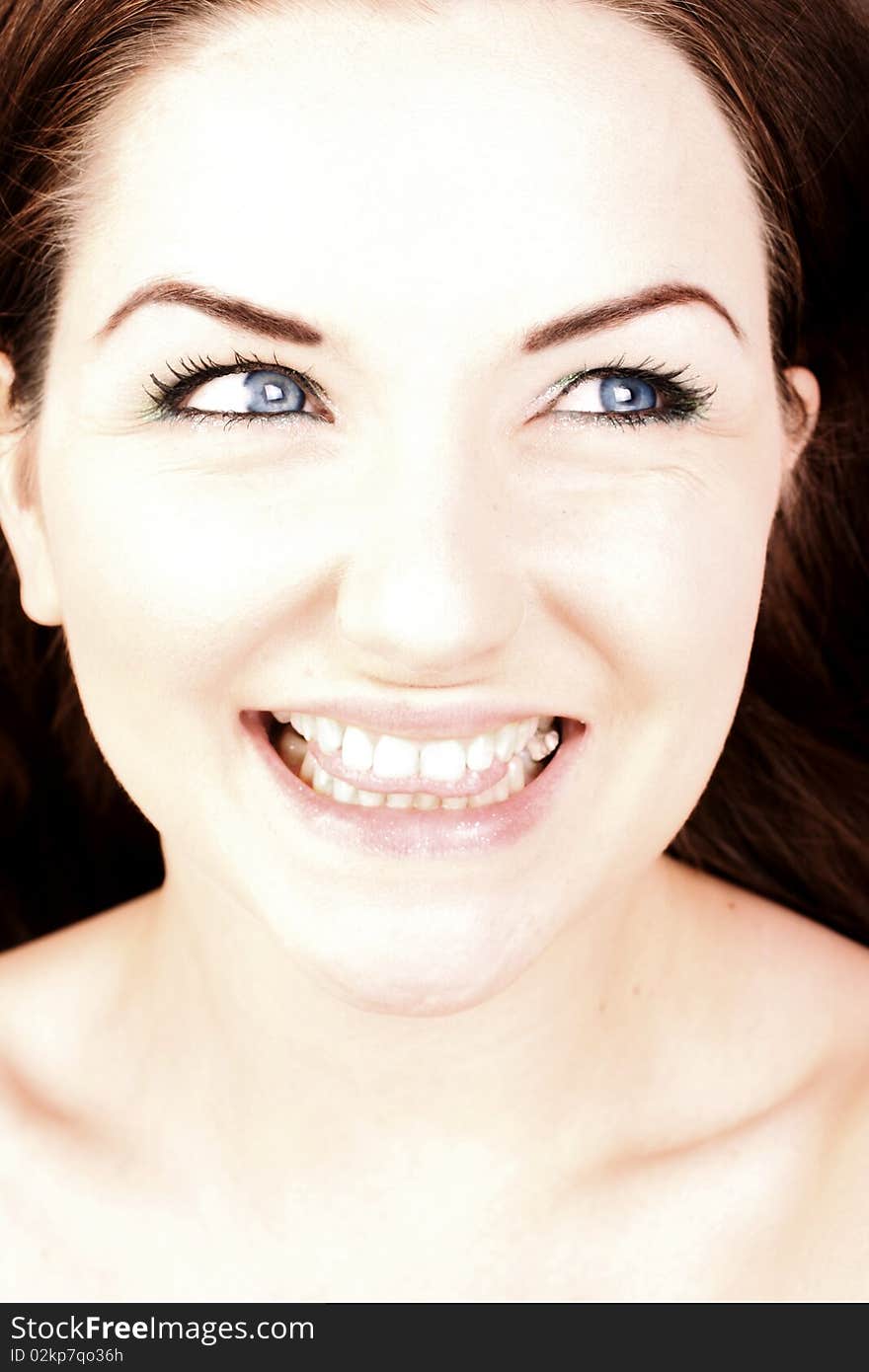 A close up of a woman smiling and looking to the side. A close up of a woman smiling and looking to the side.