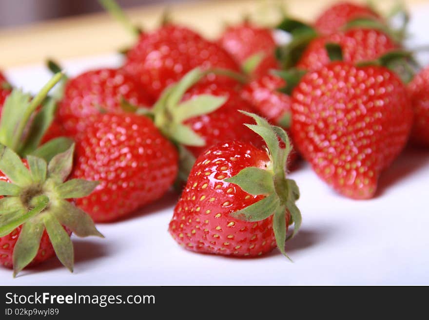 The ripe strawberry lies on a table