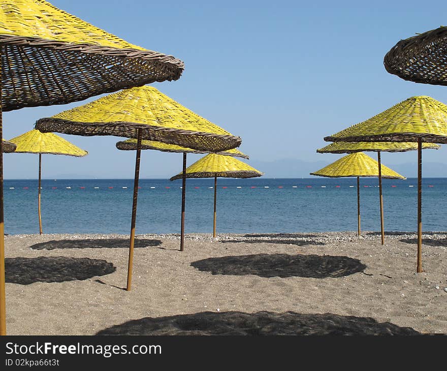 Yellow parasols at the beach of Mediterranean sea