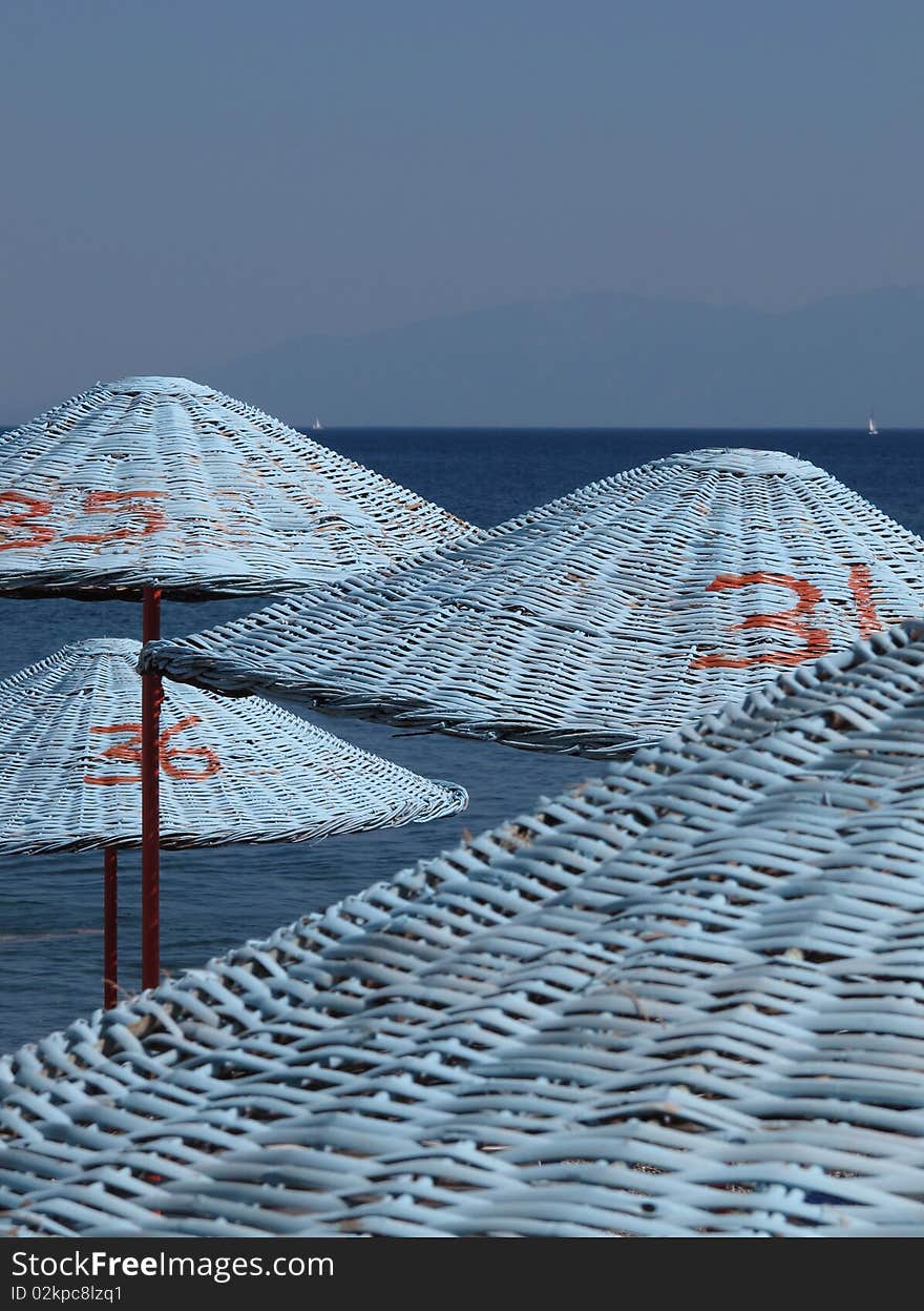 Blue parasols at the beach of Mediterranean sea