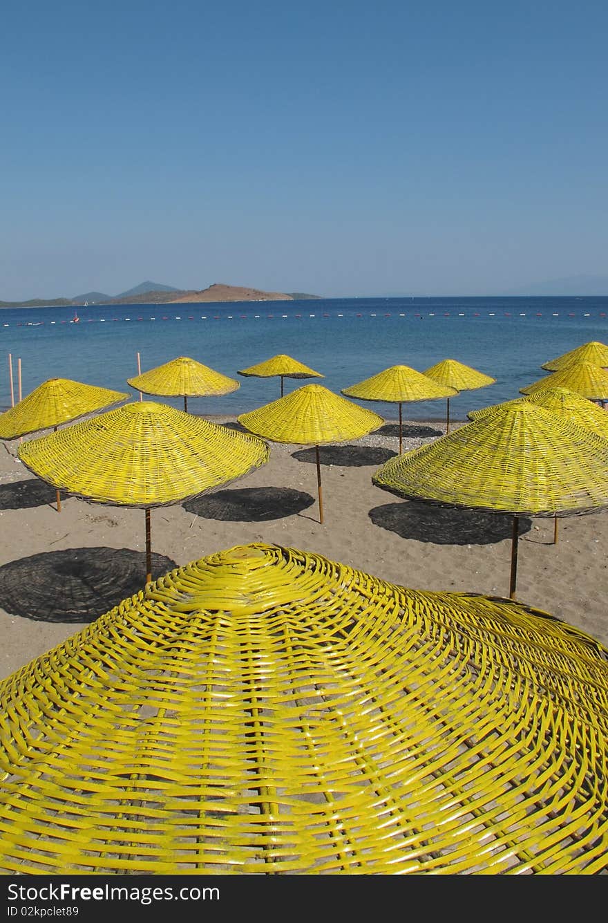 Yellow parasols at the beach of Mediterranean sea