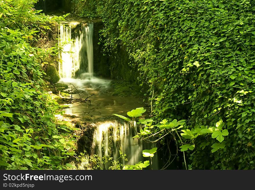 Cascade drop forest grass nature reflection river summer sunlight water waterfall. Cascade drop forest grass nature reflection river summer sunlight water waterfall