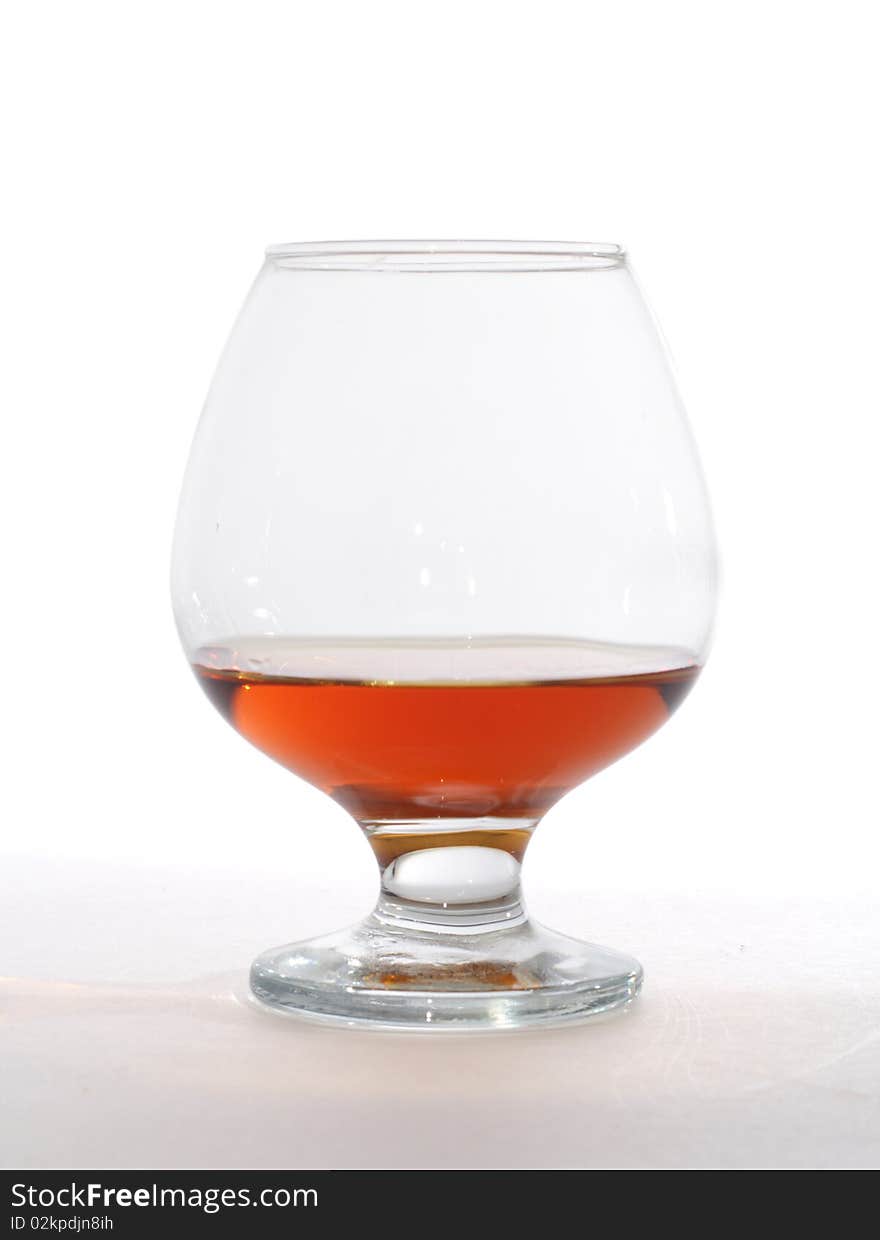 Glass of brandy isolated on white