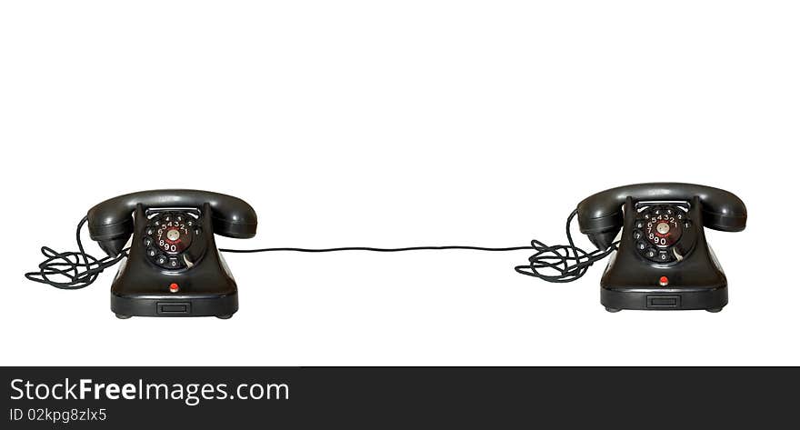 Two telephones joint on white background with cable