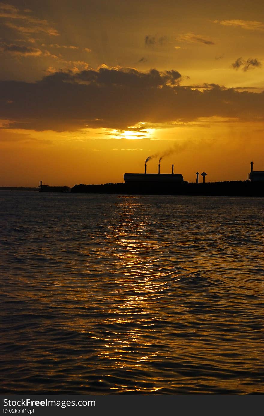 An outline of a factory against sunset. An outline of a factory against sunset