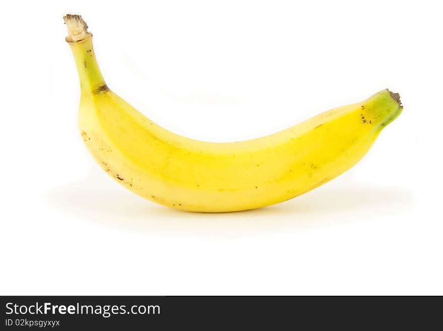 A single whole ripe fresh bright yellow banana isolated on white. A single whole ripe fresh bright yellow banana isolated on white