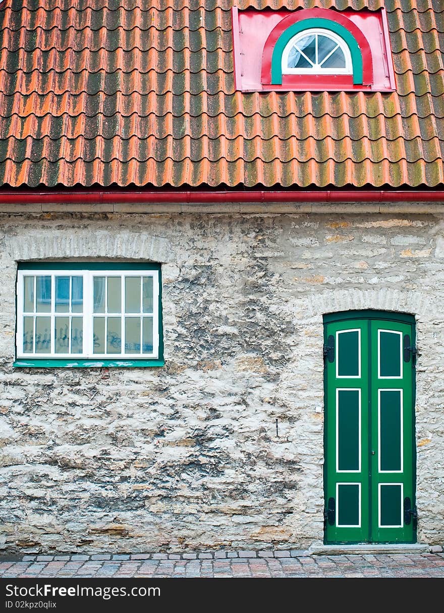 Beautiful old house with green door and windows in Tallin old town street. Beautiful old house with green door and windows in Tallin old town street