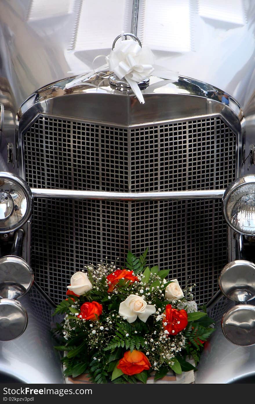 Just married car with flowers and white ribbon