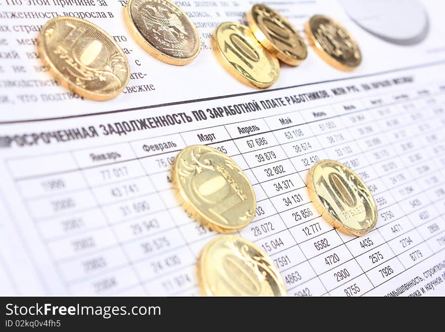 Ten rouble coins laying on the russian newspaper. Ten rouble coins laying on the russian newspaper.