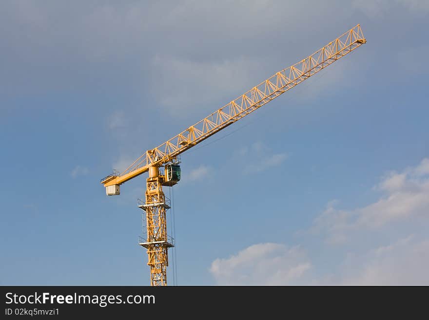 Crane over blue sky with clouds