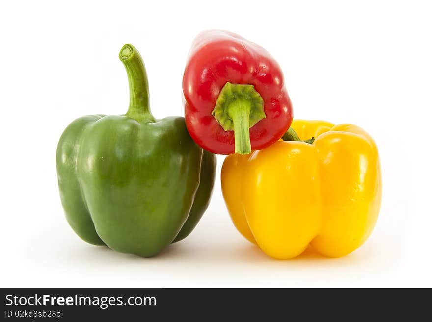 Three whole Red, Green and Yellow bell peppers isolated on a white background. Three whole Red, Green and Yellow bell peppers isolated on a white background