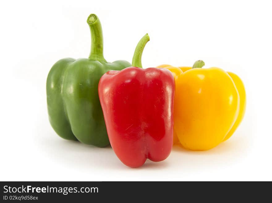 Whole Red, Green and Yellow Bell peppers isolated on a white background. Whole Red, Green and Yellow Bell peppers isolated on a white background