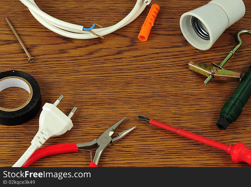 Different electrical tools lying on wooden table in circle