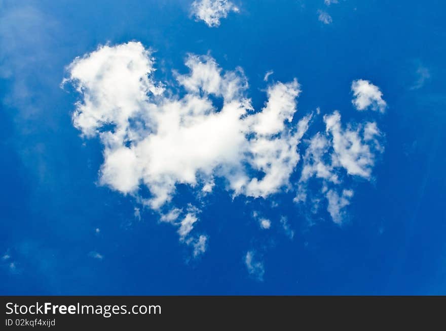 A deep blue sky with fluffy white clouds