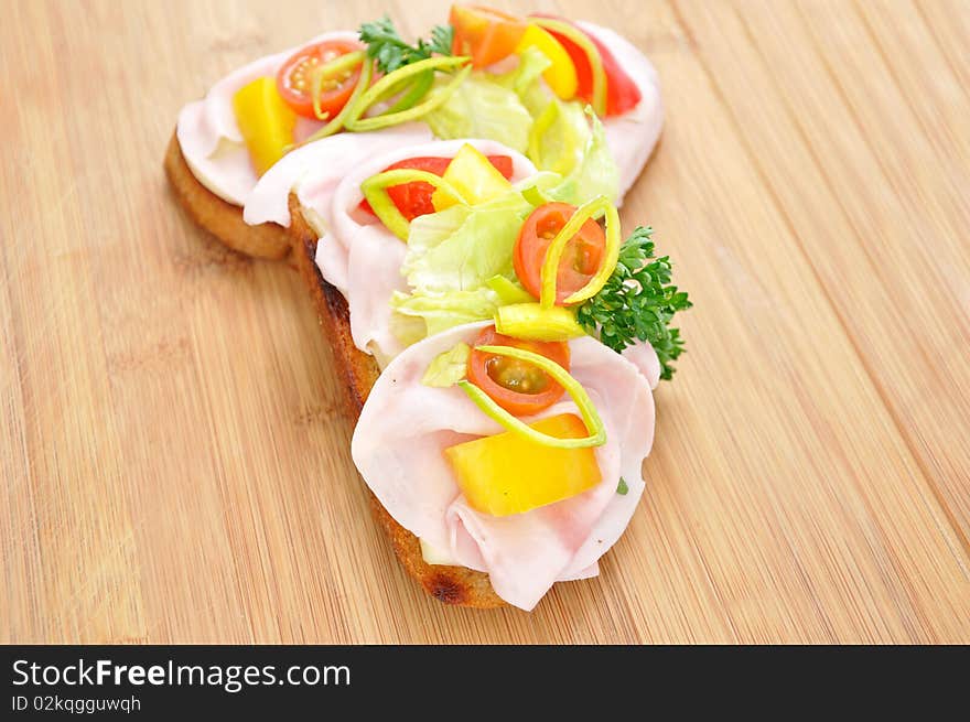 Toaste, canape, bruschette, with tomato, vegetable and ham. Toaste, canape, bruschette, with tomato, vegetable and ham