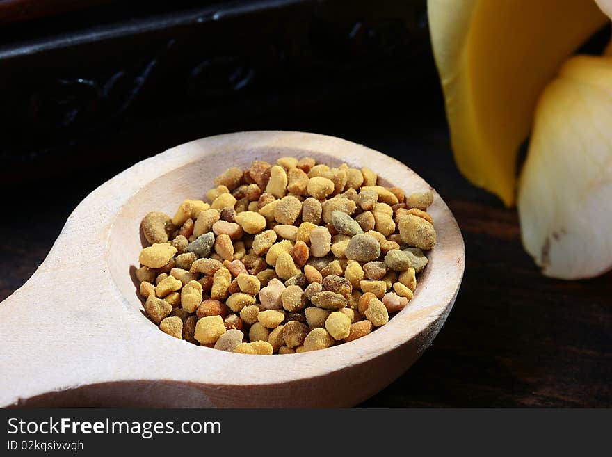 The granulated beer pollen in a wooden spoon.