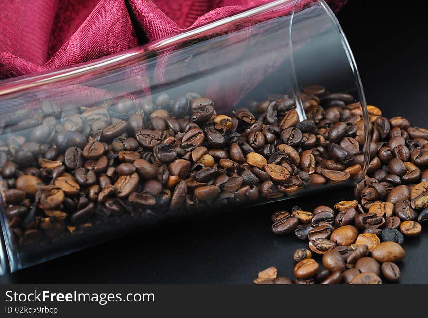 Pure glass with coffee granules on black table. Pure glass with coffee granules on black table