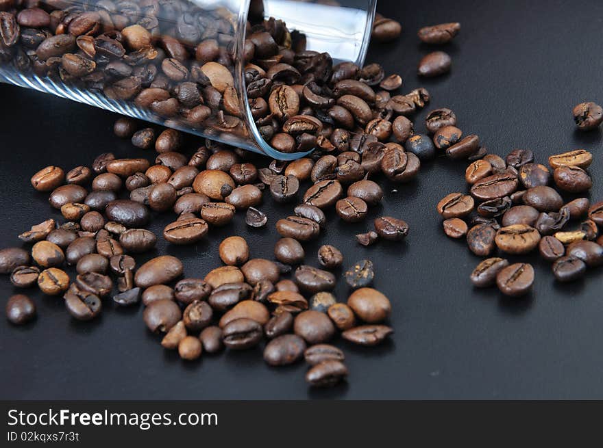 Pure glass with coffee granules on black table