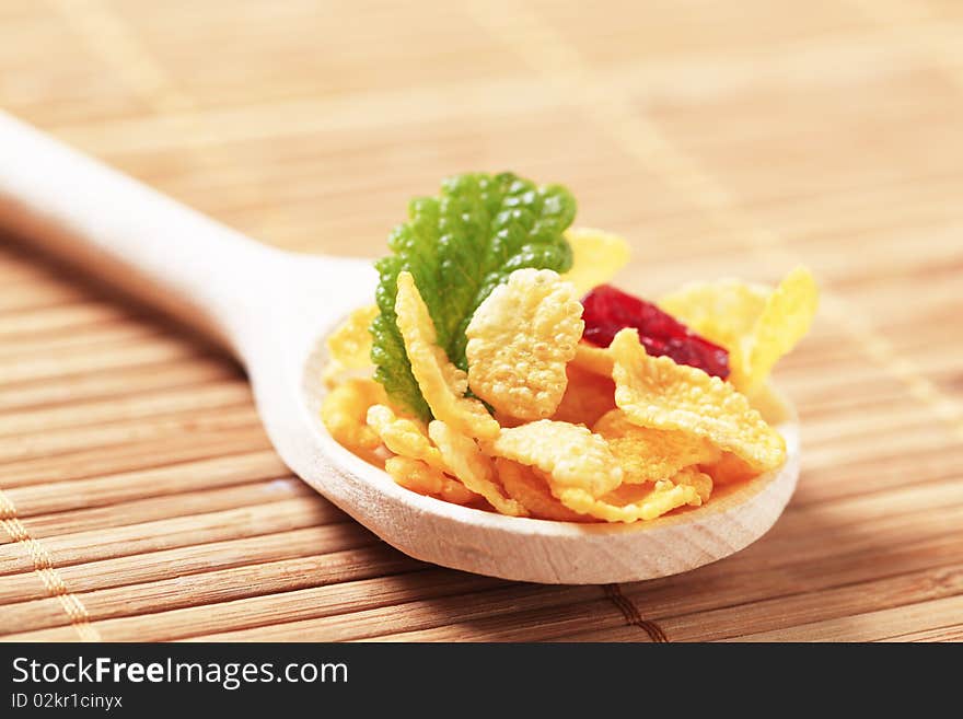 Corn flakes on wooden spoon