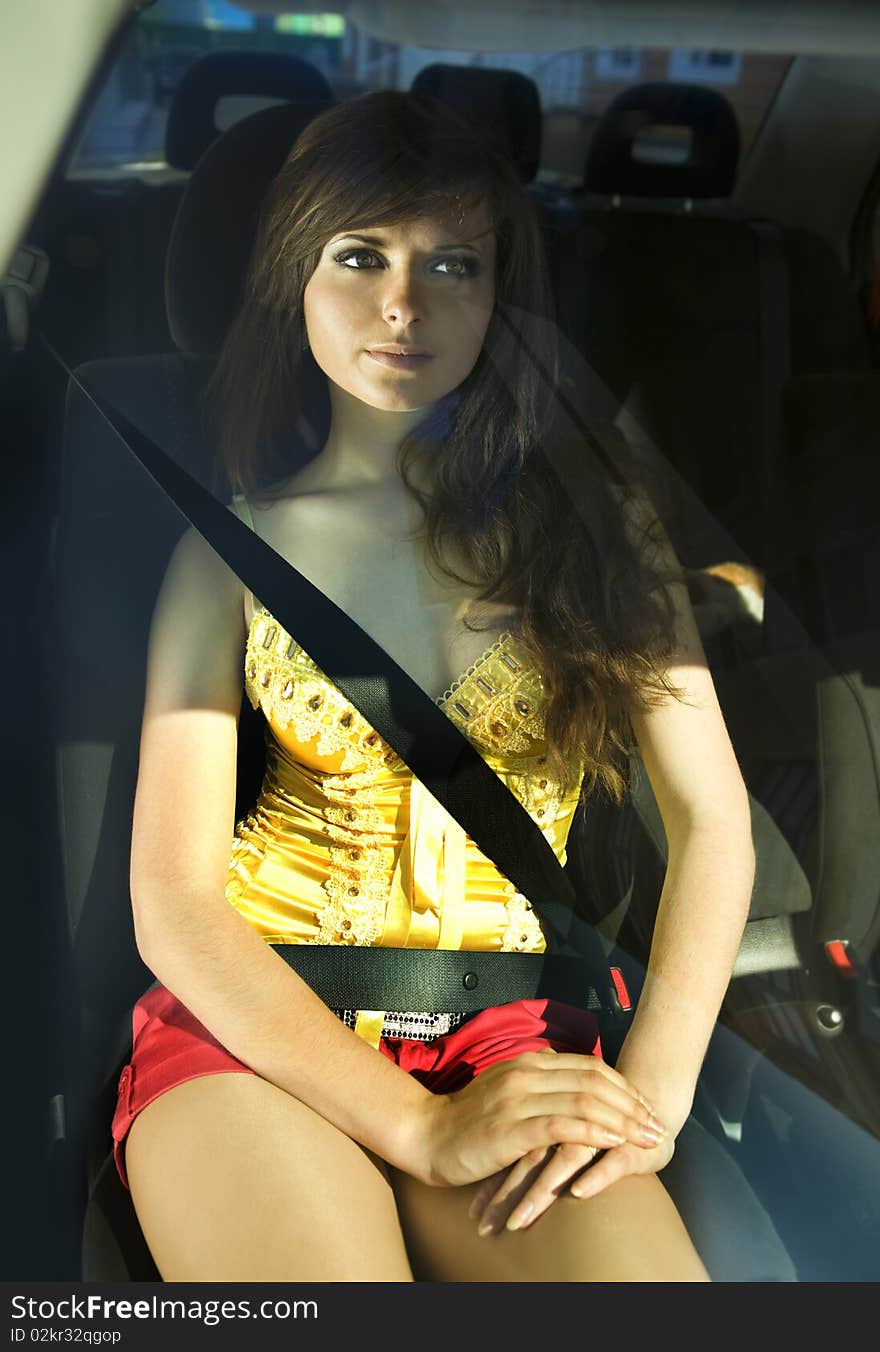 Beautiful girl in car fastened by seat belt. Beautiful girl in car fastened by seat belt