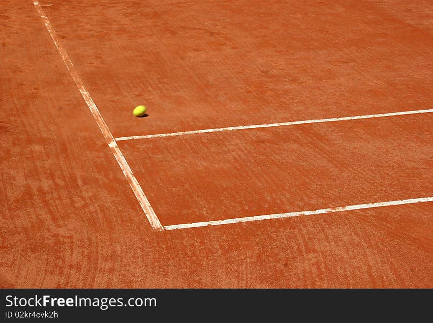 Tennis court with blurred ball on the move