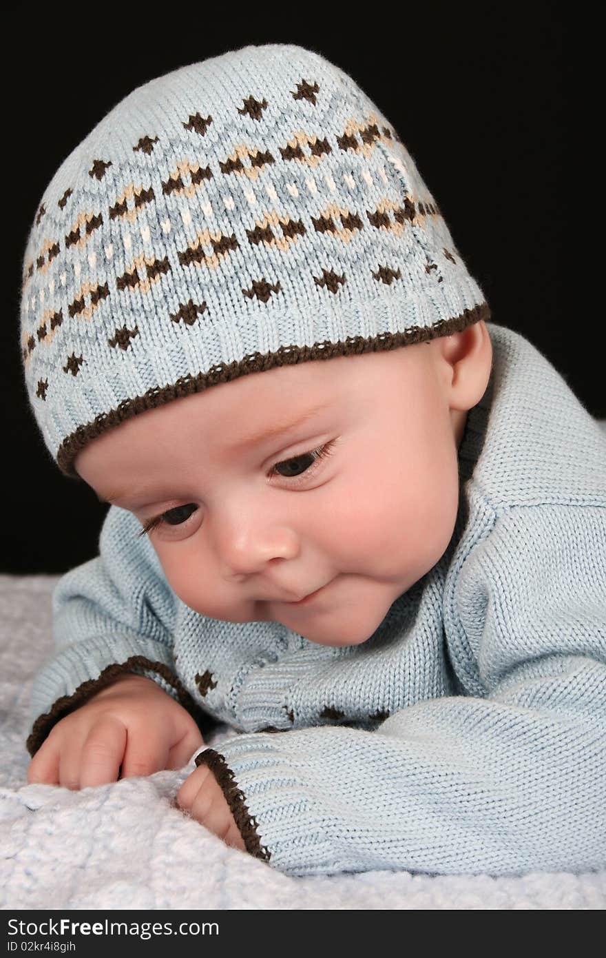 Cute four month old baby boy lying on his tummy